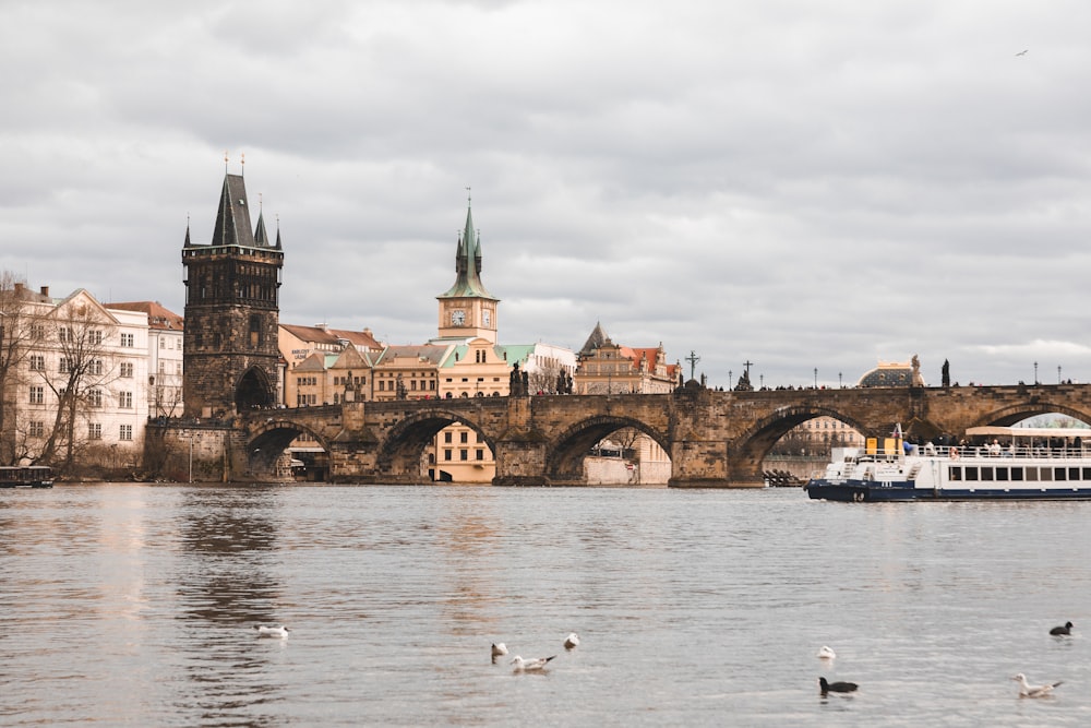 a boat on a river with a bridge in the background