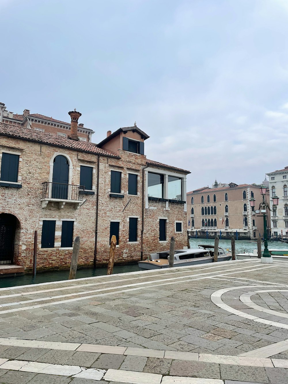 a brick building next to a body of water