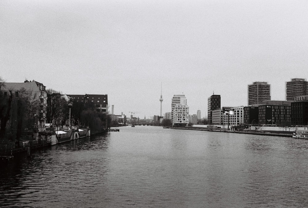 une photo en noir et blanc d’une rivière dans une ville