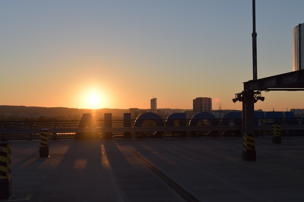 the sun is setting over a parking lot