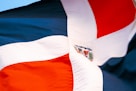a close up of a flag with a blue sky in the background