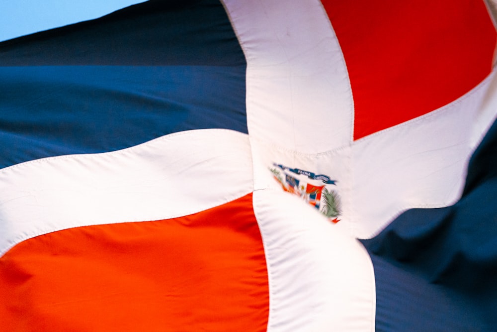 a close up of a flag with a blue sky in the background