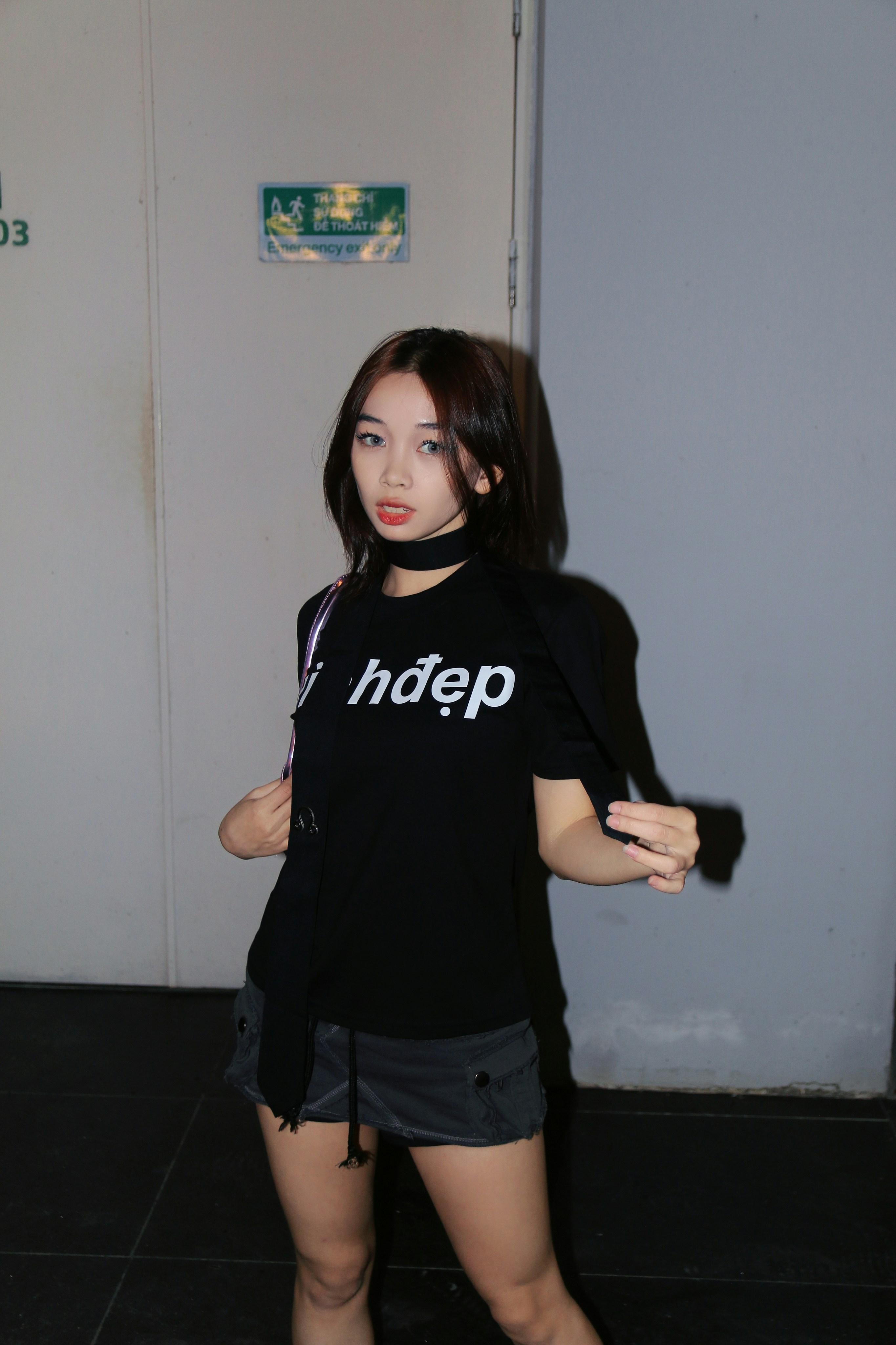 a woman standing in front of a white door