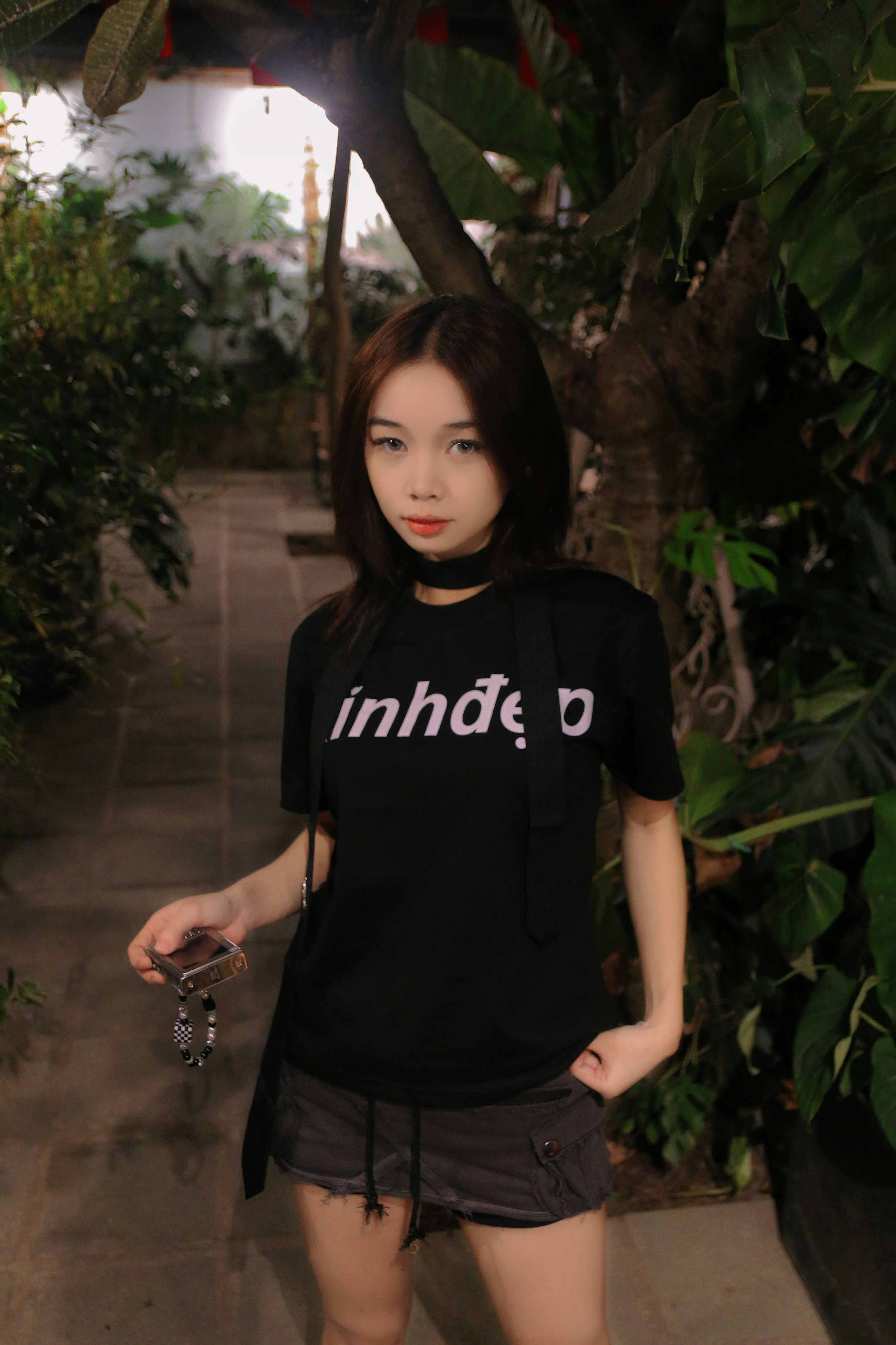 a woman standing in front of some plants