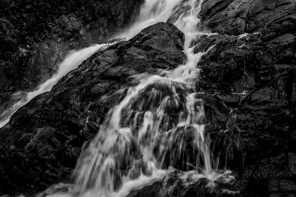 a black and white photo of a waterfall