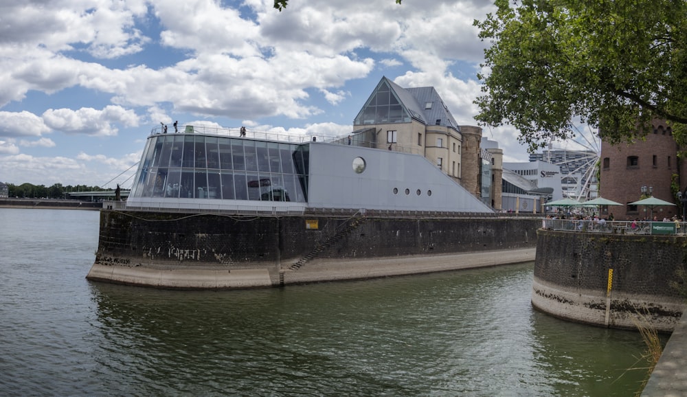 a large building sitting on the side of a river