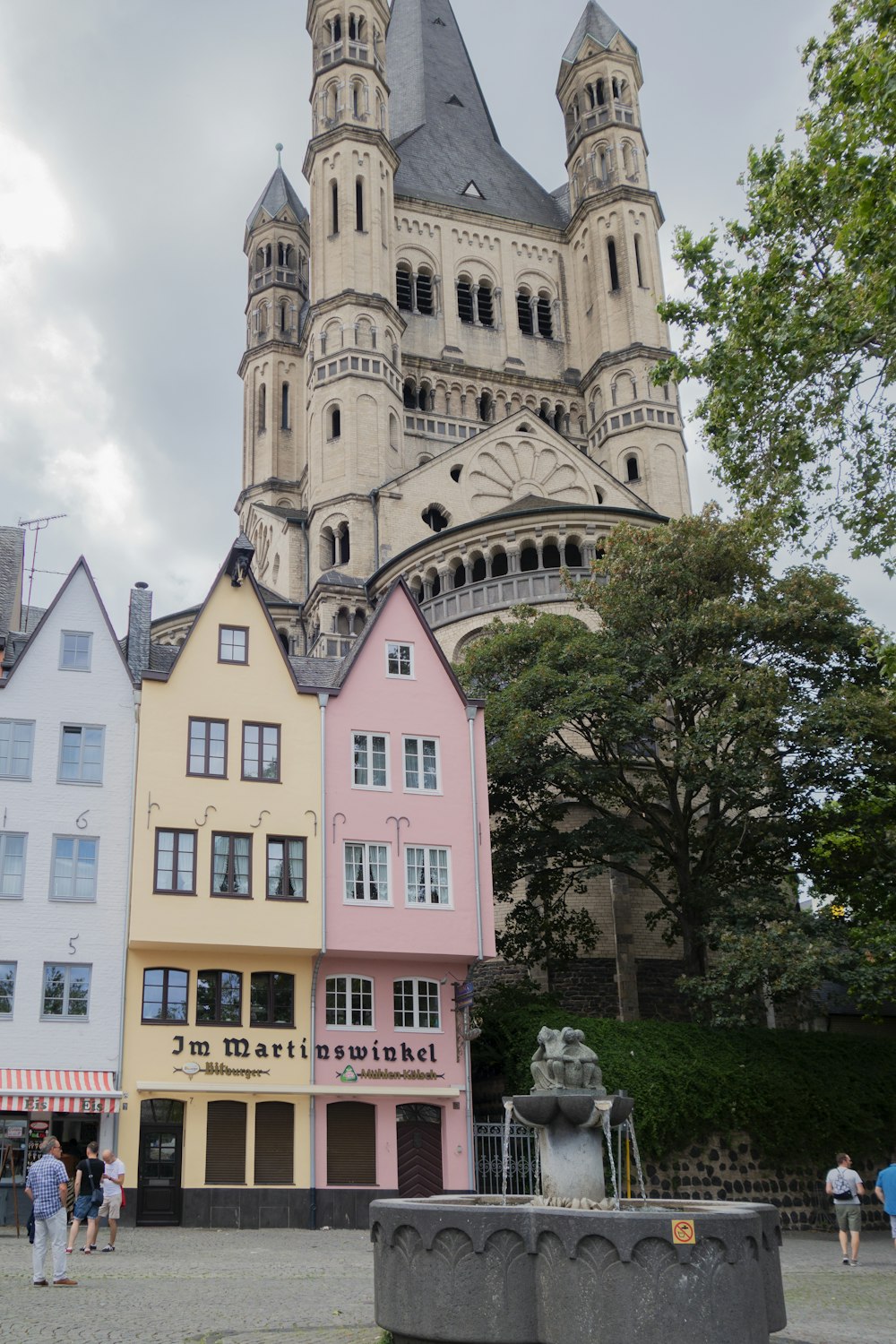 a group of buildings with a clock tower in the background