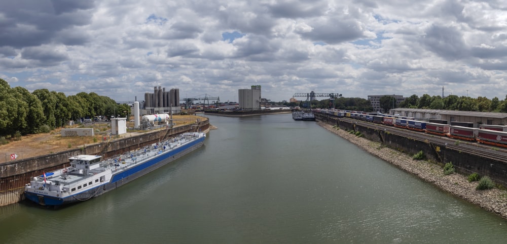 a large boat traveling down a river next to a bridge