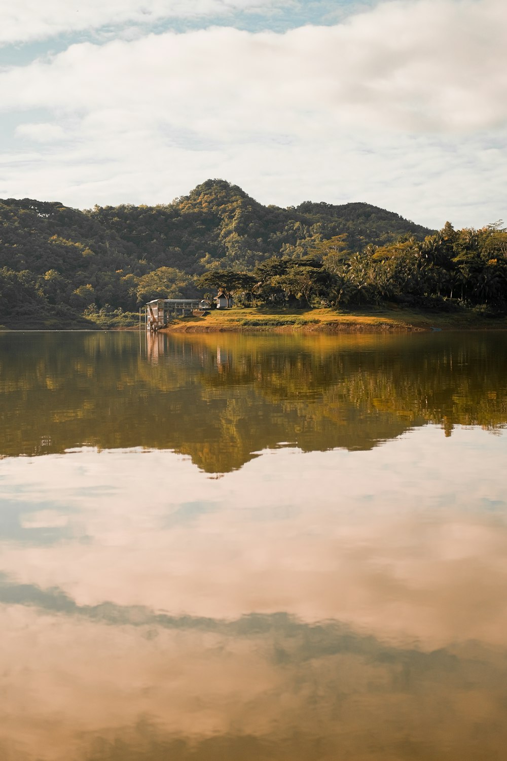 a large body of water with a mountain in the background