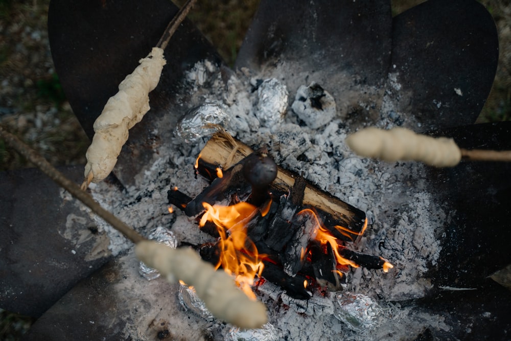 a close up of a campfire with a bunch of sticks sticking out of it