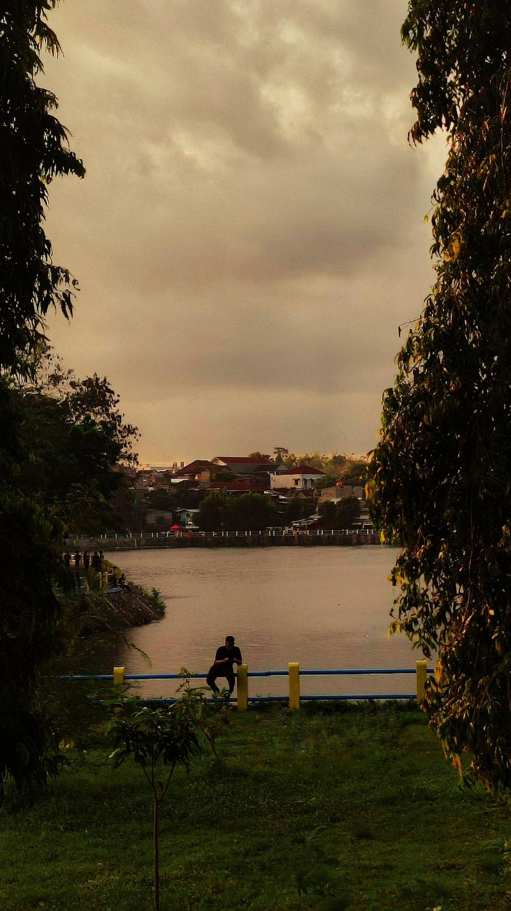 a person sitting on a bench near a body of water