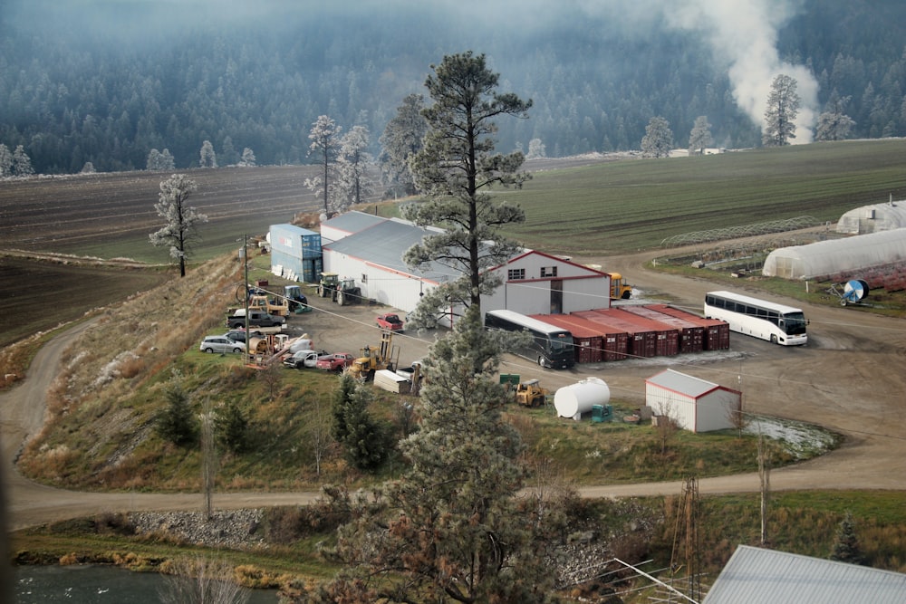 an aerial view of a farm with trucks and farm buildings