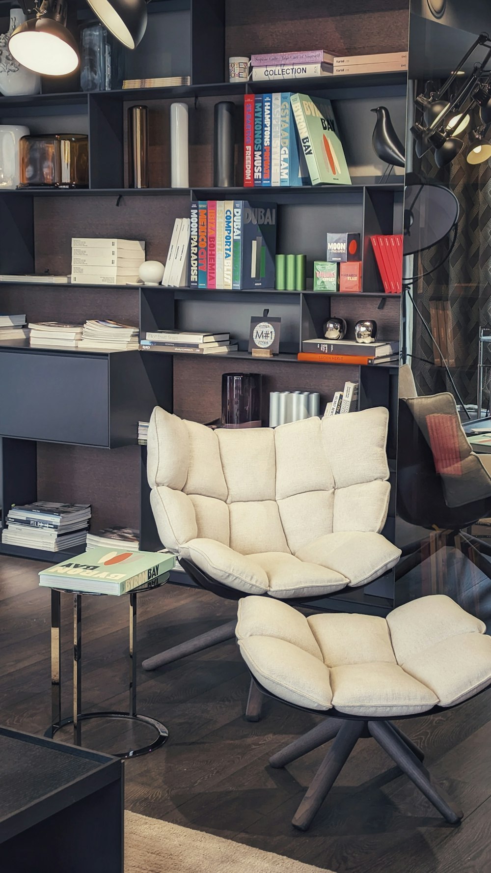 a chair and ottoman in a room with bookshelves
