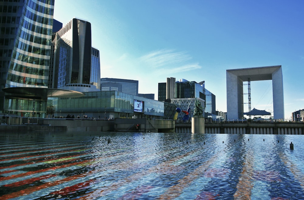 a body of water with buildings in the background