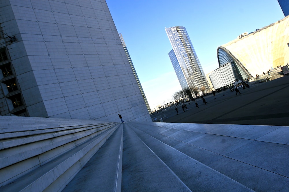 a person walking up a set of stairs in front of a building