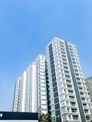 a tall white building with a sky background