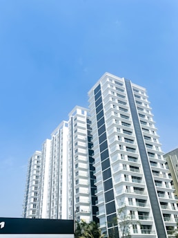 a tall white building with a sky background