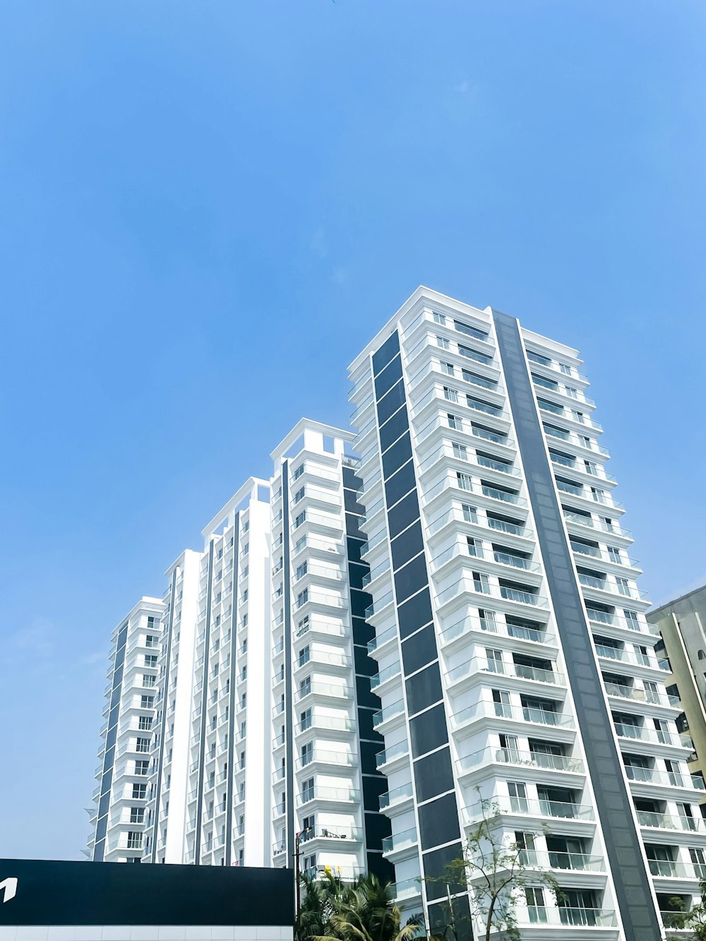 a tall white building with a sky background