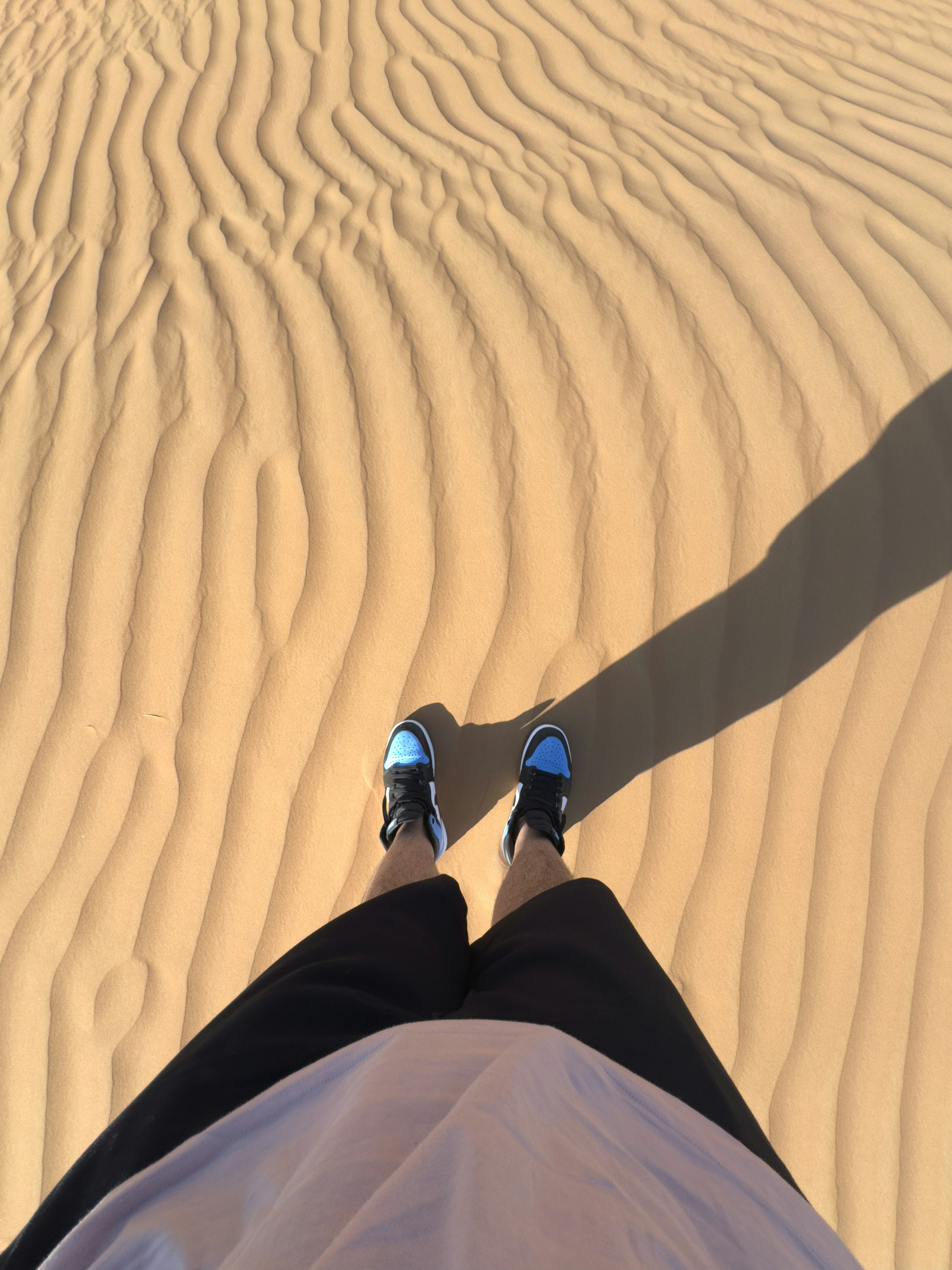 a person with their feet up in the sand