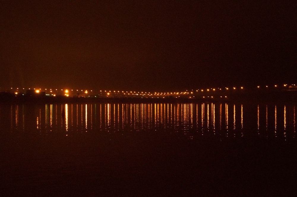 a body of water with a bridge in the background