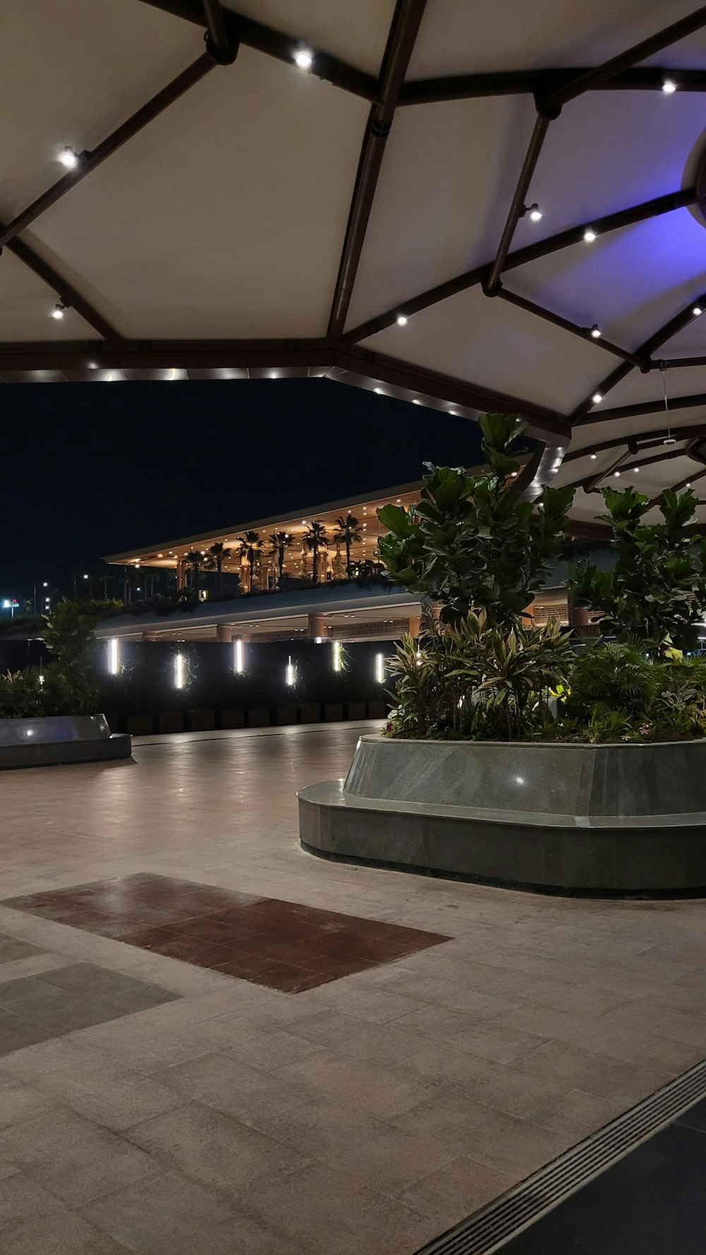 a view of a building at night from a patio