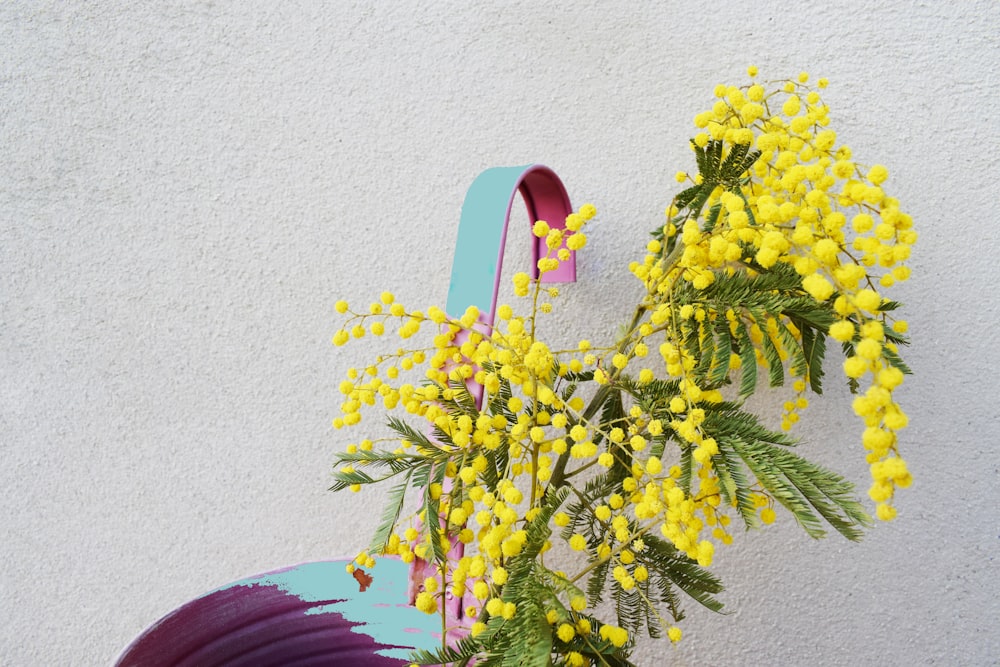 a vase with yellow flowers on a table