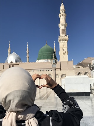 a woman making a heart shape with her hands