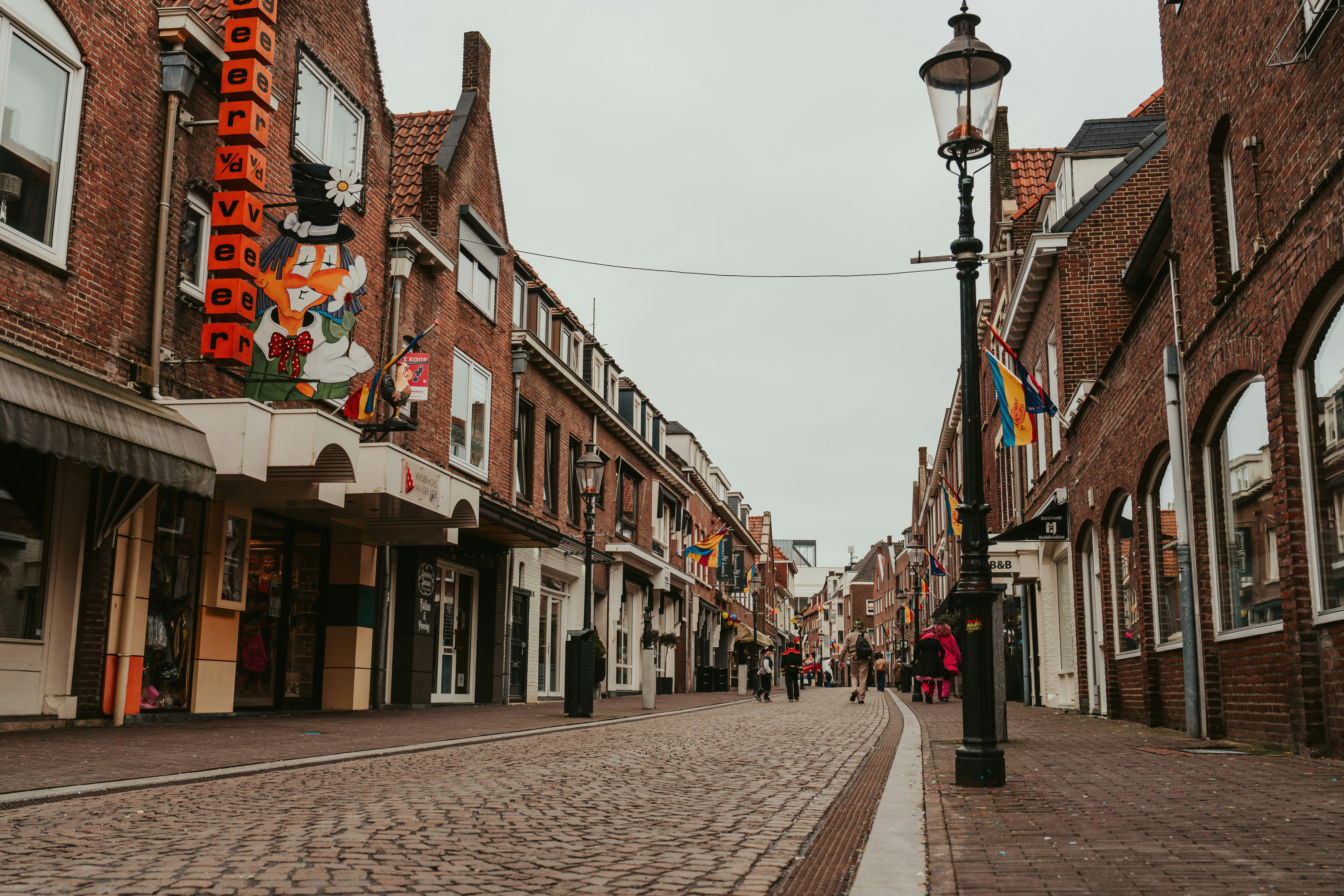 a cobblestone street lined with brick buildings