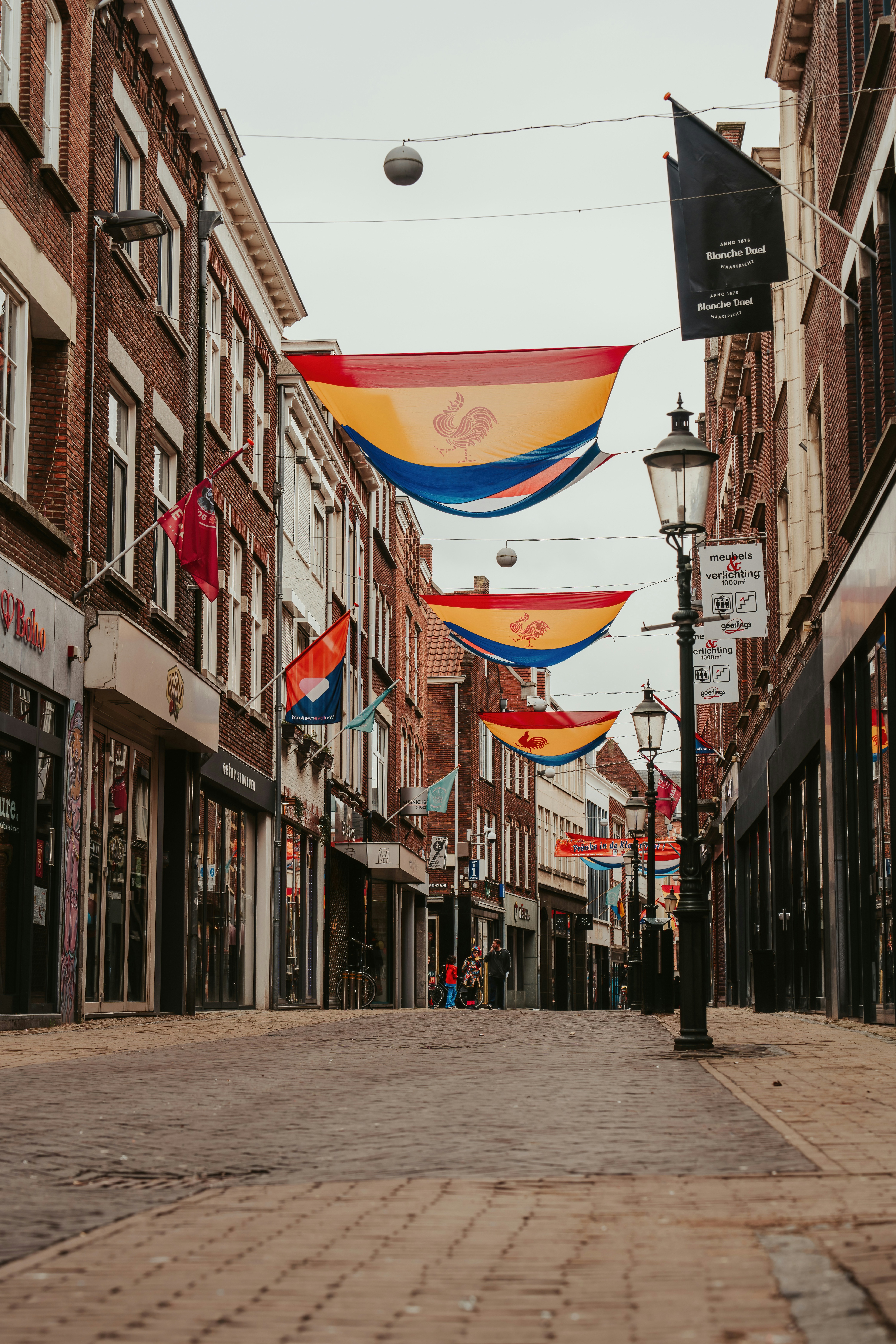 a city street with flags hanging from buildings