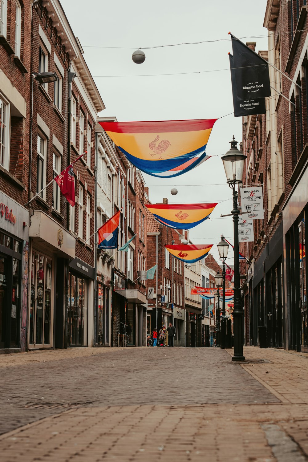 a city street with flags hanging from buildings