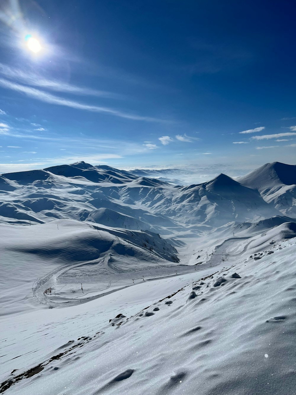 a person riding skis on top of a snow covered slope