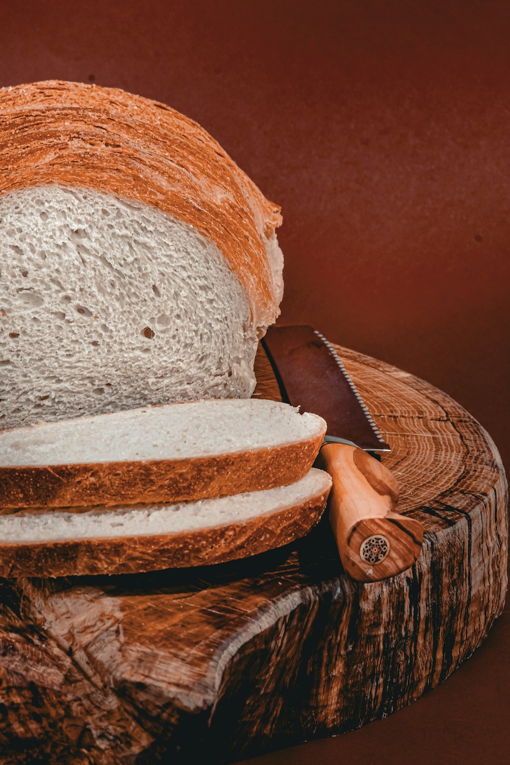 a loaf of bread sitting on top of a wooden cutting board