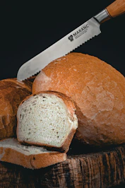 a loaf of bread with a knife on top of it