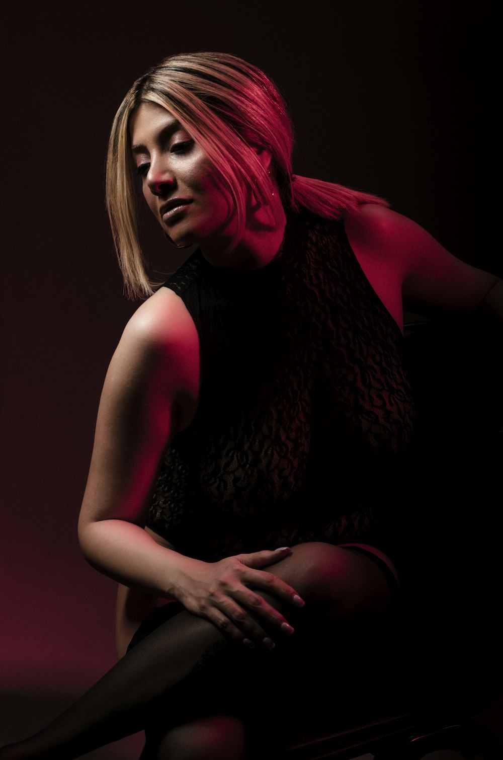 a woman sitting on a chair in a dark room