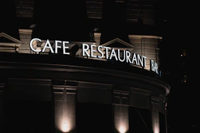 a restaurant sign is lit up at night
