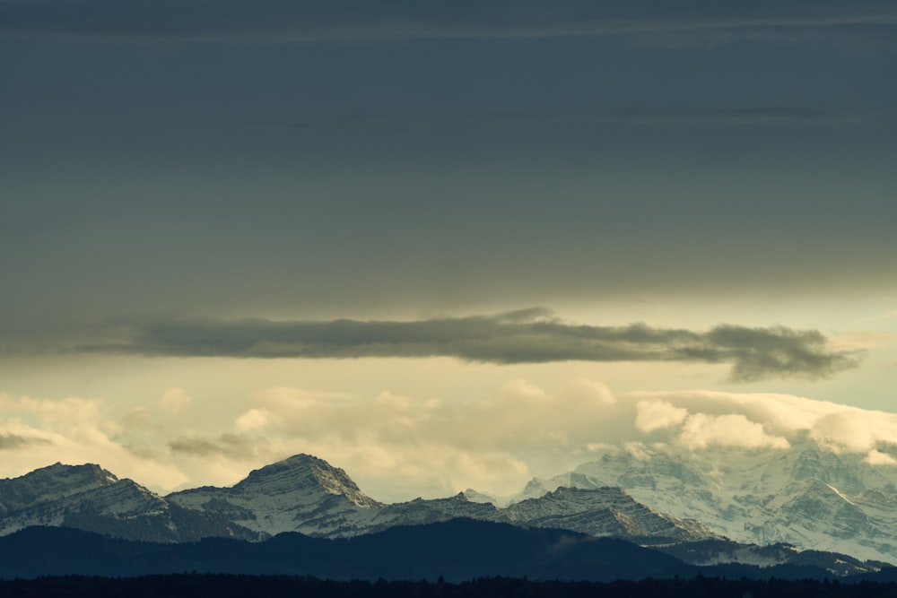 a view of a mountain range under a cloudy sky