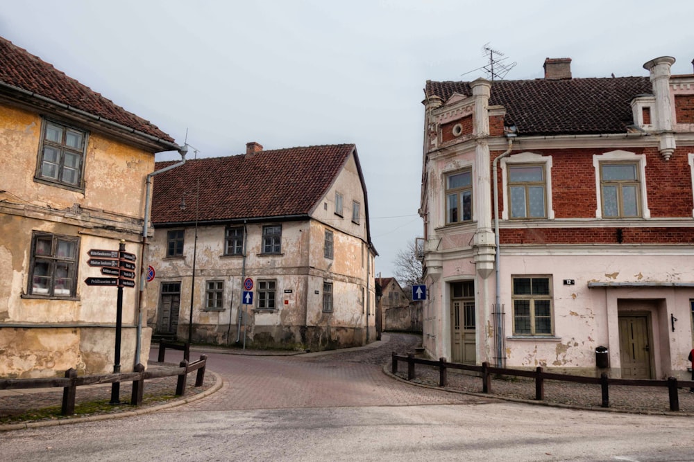 an empty street with old buildings in the background