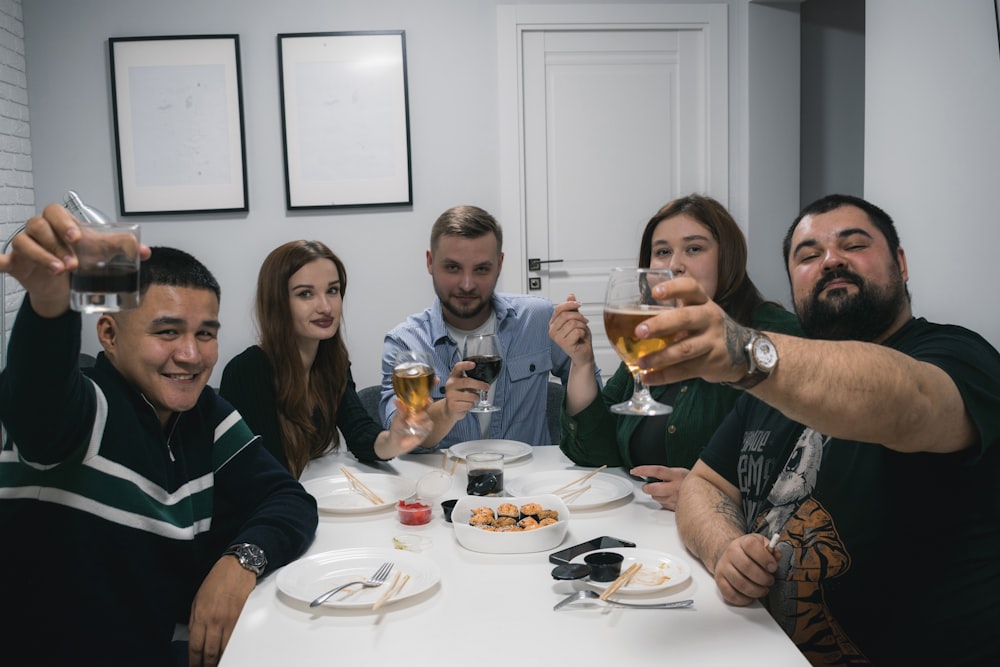 a group of people sitting around a table drinking wine