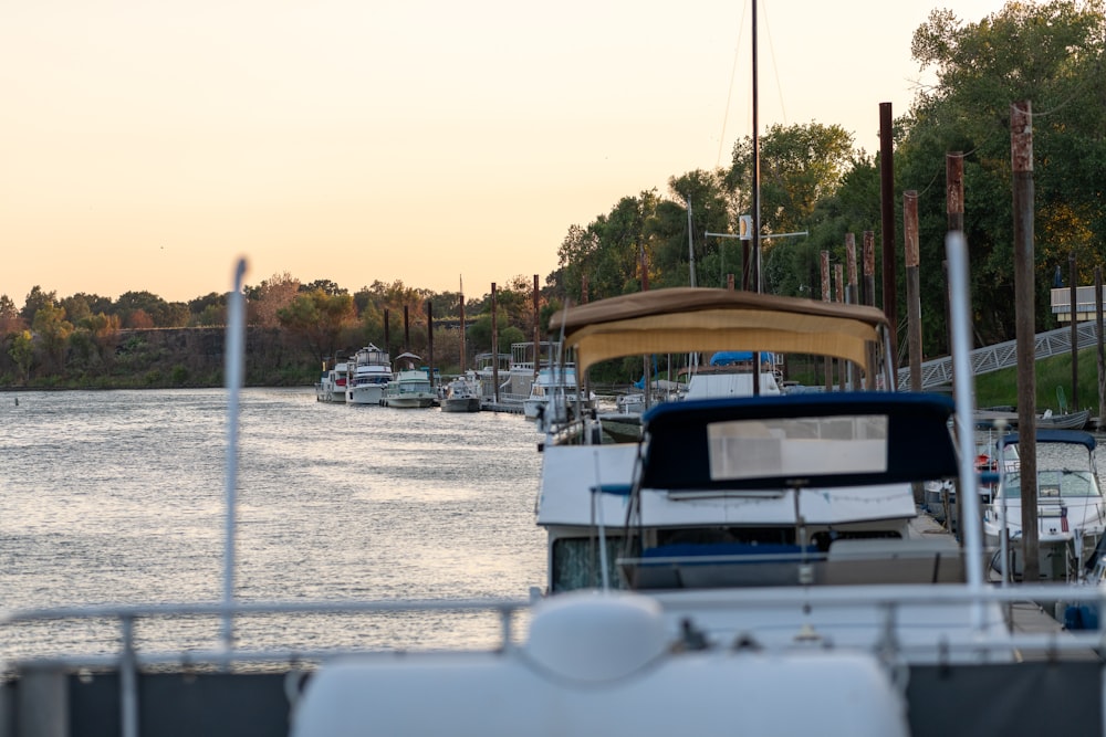 a row of boats sitting next to each other on a body of water