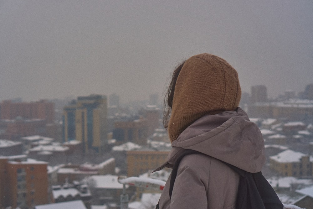 a person standing on top of a snow covered hill