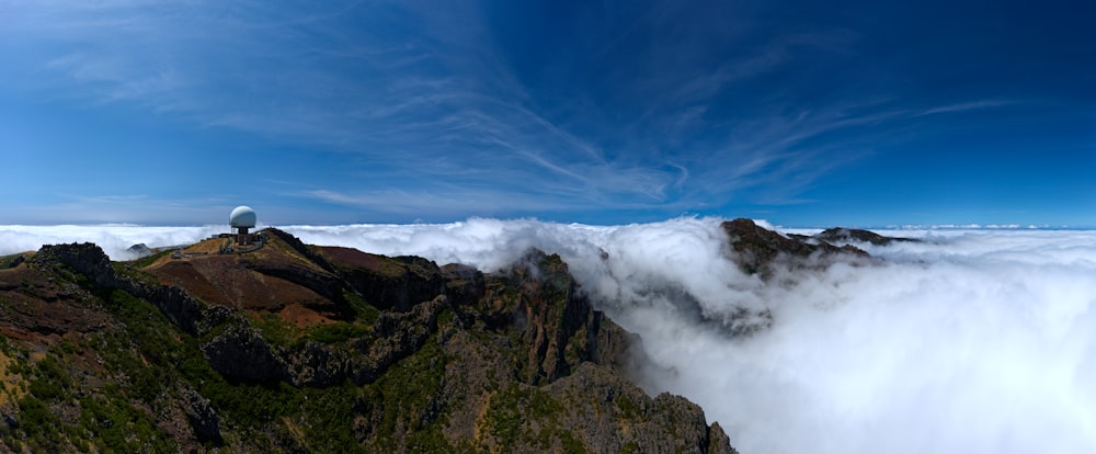 a bird's eye view of a mountain with clouds