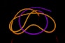 a close up of a neon colored object in the dark