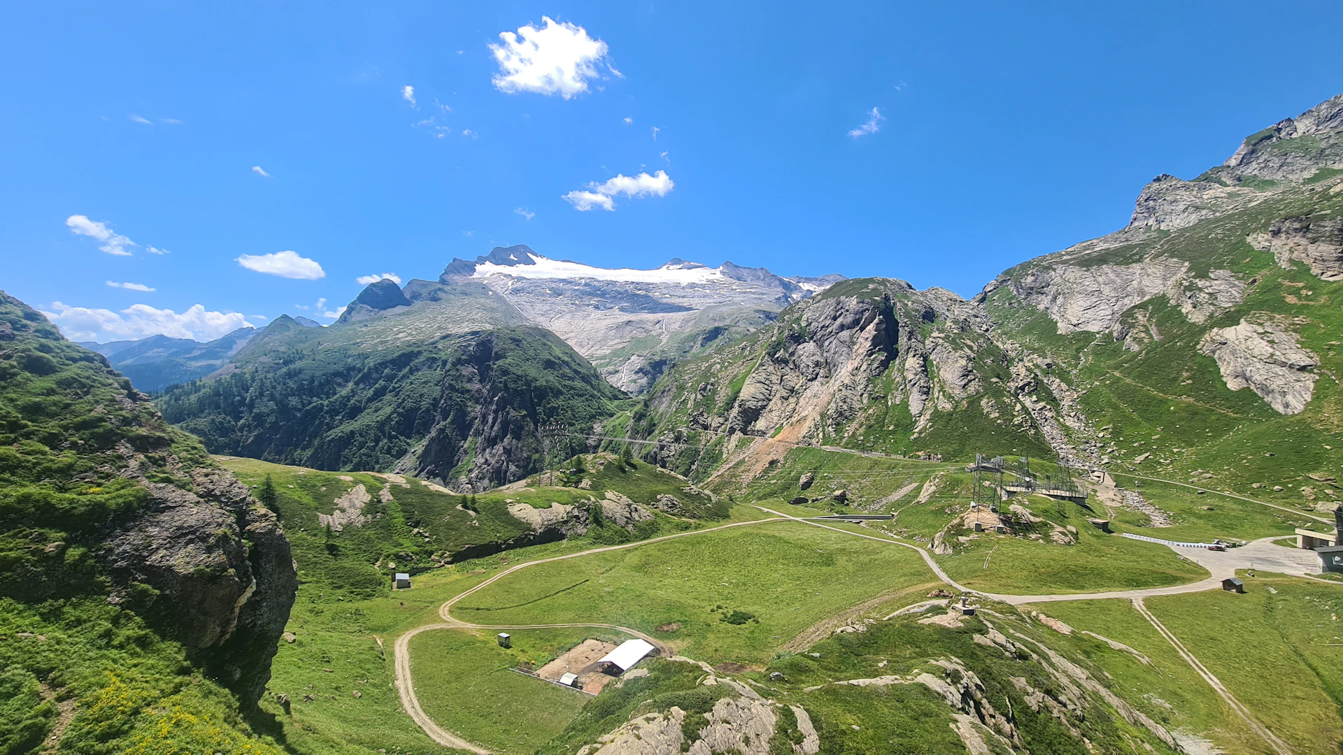 an aerial view of a mountain valley with a road winding through it