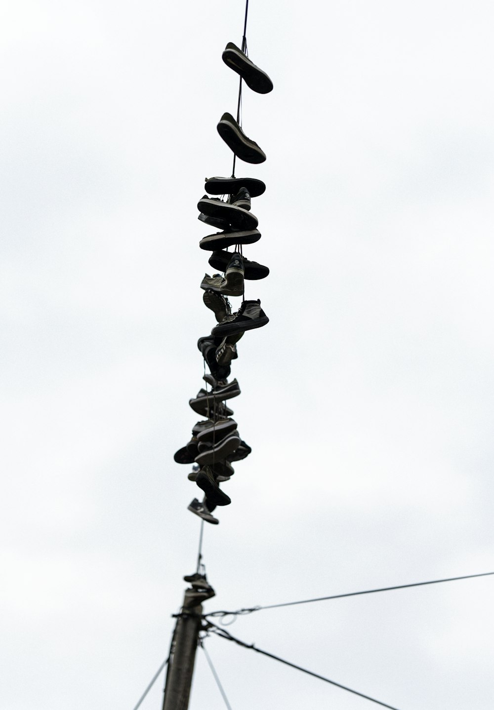 a pole with a bunch of shoes hanging from it