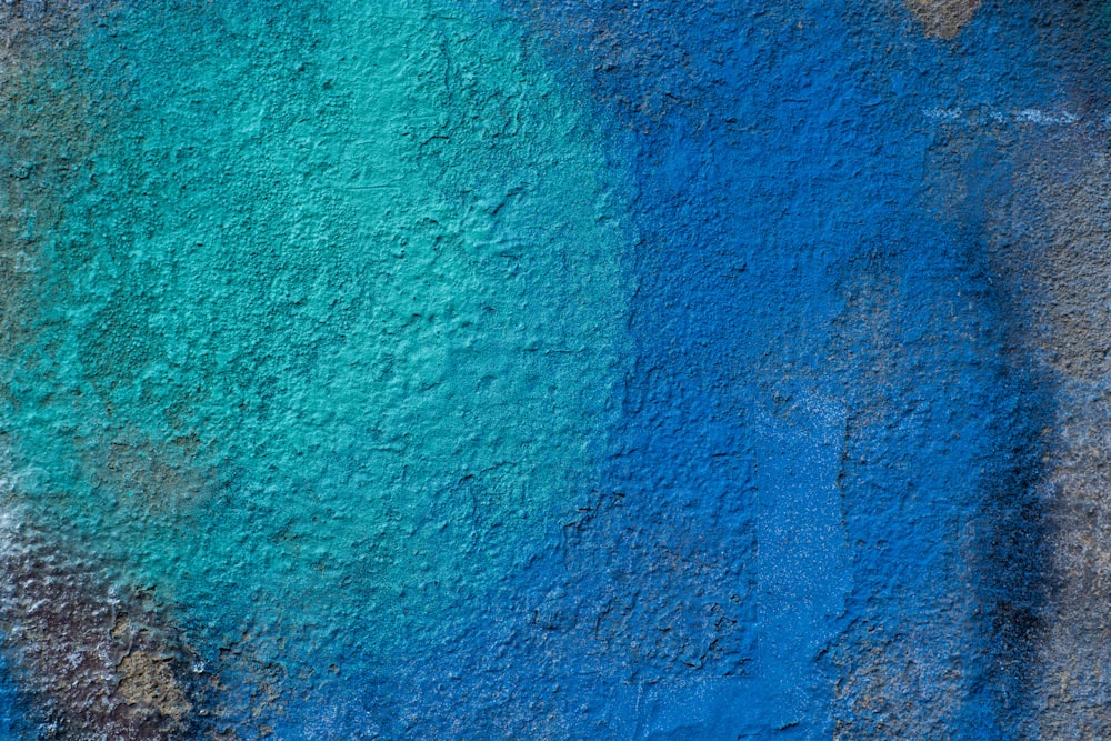 a close up of a blue and green wall