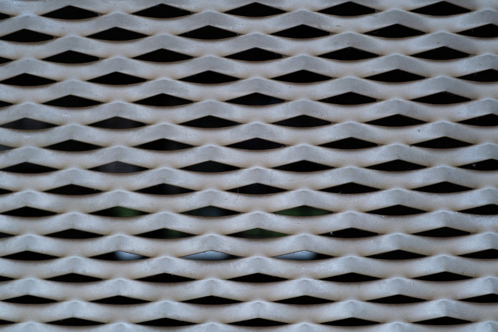 a close up of a metal grate with wavy lines