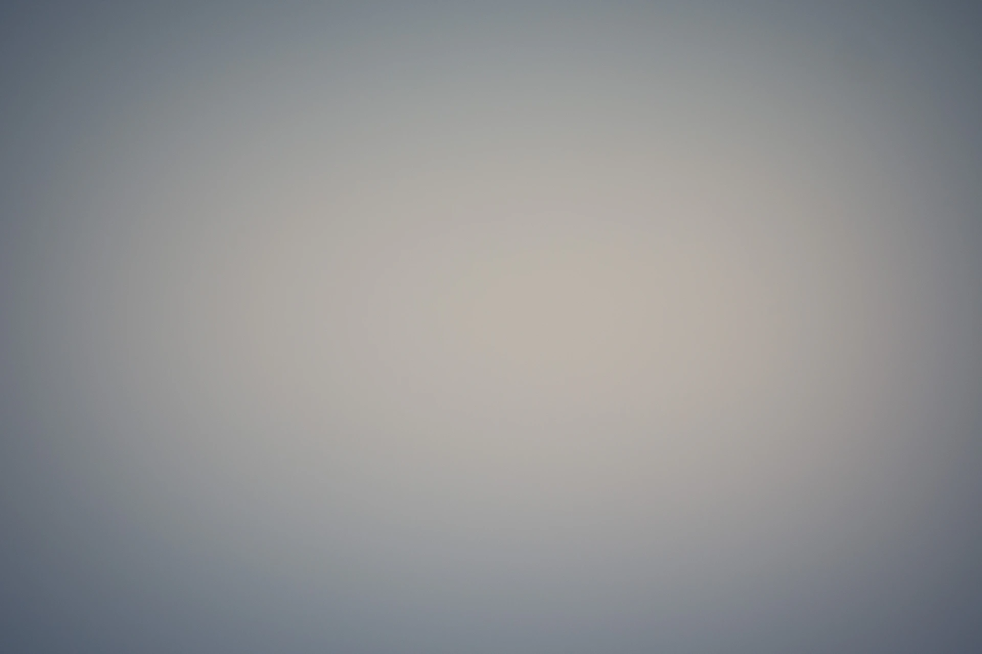 an airplane flying in the sky on a foggy day