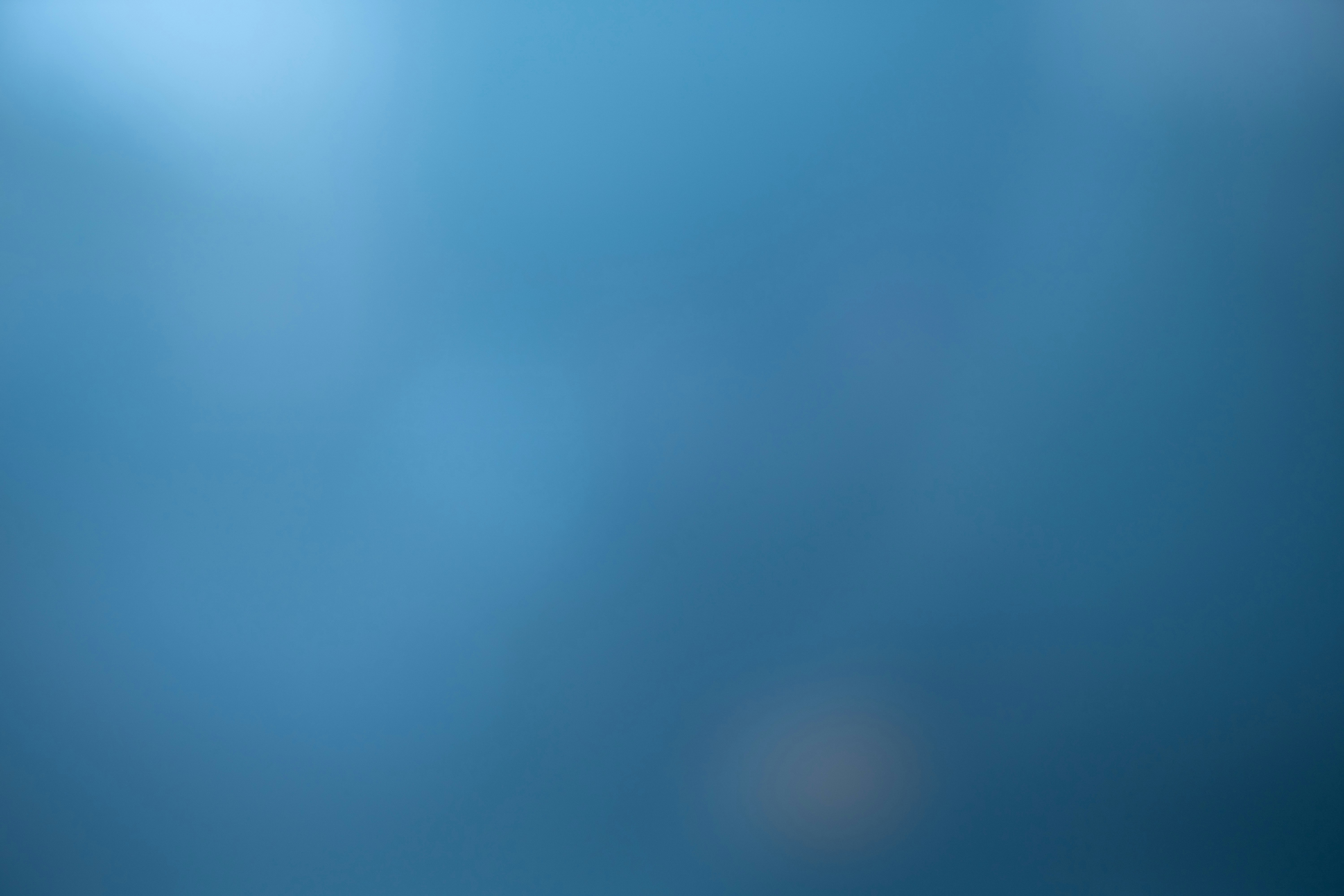 a blurry image of a blue sky with clouds