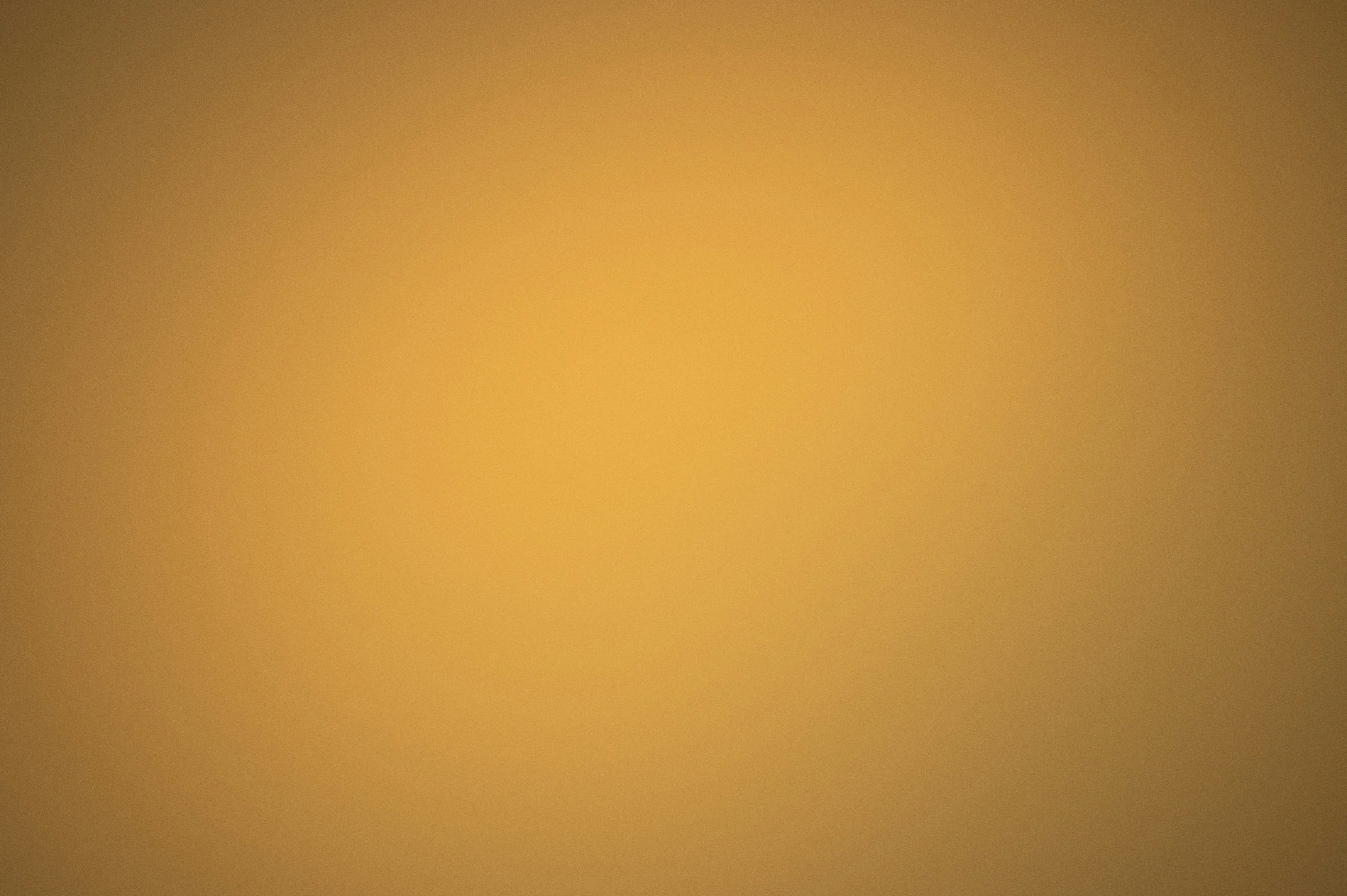 a blurry image of a yellow and brown background