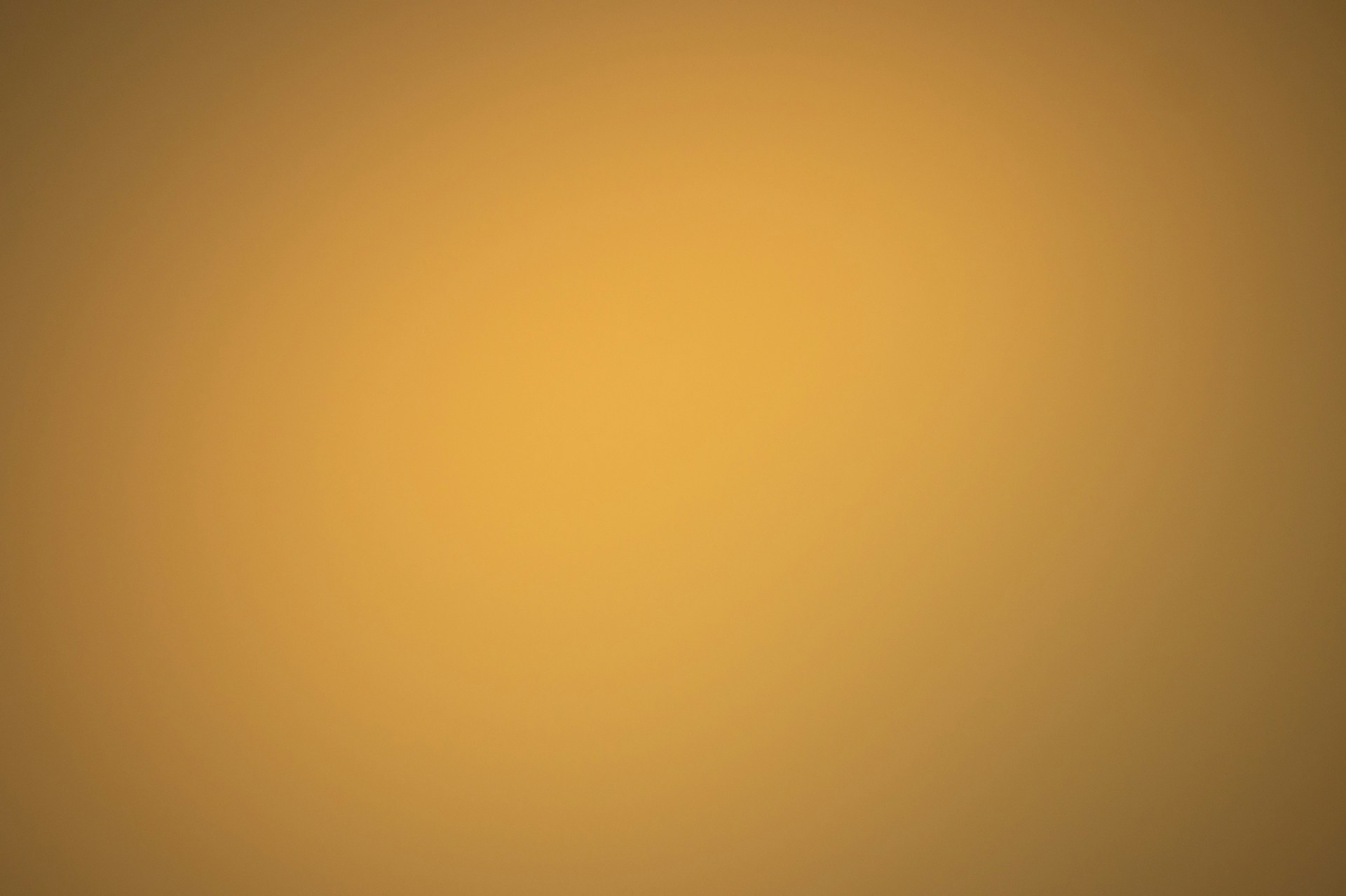a blurry image of a yellow and brown background